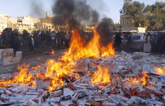 ISIS fighters burn confiscated cigarettes in the city of Raqqa, April 2, 2014. (Reuters)