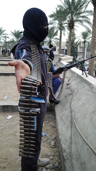 Armed Iraqi men stand guard near the home of Sunni Muslim MP Ahmed al-Alwani Photo: AFP/Getty